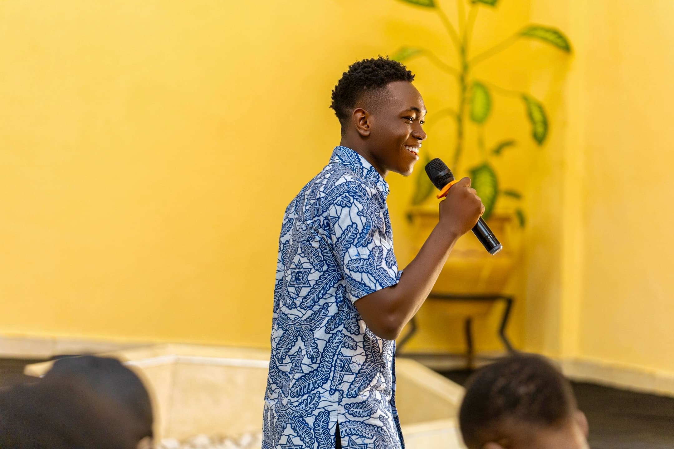 Nana Asiamah speaking with a microphone